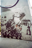 On the inner face of the western stele is etched a larger than life representation of members of the 7th Battalion Royal Australian Regiment being airlifted by U.S. helicopters from the fishing village of Lang Phuoc Hai to return to Nui Dat. It is a blow-up of an Army public relations photo taken by Sgt. Mike Coleridge and preserves a typical real life image of the conflict. The image was engraved in situ on 400 pieces of variable sized, triangular South Australian Imperial Black granite. Eighty-one one meter photographs were stuck on top of two layers of sandblasting tape and, in a very delicate operation; an engraver's tool was used to cut through the photographs and two layers of tape without touching the stone. The exposed stone was sandblasted to a depth of 1 mm to create the grey effect and the tape was then removed, leaving behind the image.