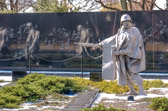 The blowing ponchos give motion to the column, so you can feel them walking up the hill with the cold winter wind at their backs, talking to one another. At nighttime the fronts of the statues are illuminated with a special white light; the finer details of the sculpture are clearly seen and the ghosts appear.