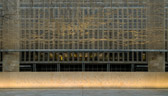 A stainless steel, woven "tapestry" made by artist Tomas Osinski stands behind the statues and depicts the cliffs at Normandy.