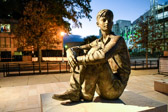 Dreams of a Barefoot Boy<br /><br />This memorial centers on the sculpture of Eisenhower as a young man, located in the northwest corner. How did a small-town boy from Kansas grow up to be the leader of the free world? <br /><br />Here is Dwight D. Eisenhower at about 15 years old. He is sitting wearing boots, overalls and a simple button down shirt, his arms are on his knees. <br /><br />The sculpture by Sergey Eylanbekov is human scale.  Young Eisenhower looks peaceful, happy, maybe because he is in Abilene, Kansas, his Home town.