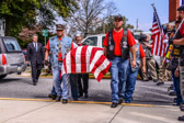 “Duff” leads the Warriors' Watch Riders honor guard into the funeral home.