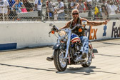 Ladies and Gentlemen this afternoon Dover International Speedway would like to recognize some of our Veteran heroes who have fought for our freedom and we also remember those who lost their lives and those who became Prisoners of War or Missing in Action.<br />Would All Veterans that are comfortable to do so, Please stand!