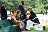 Joan Marie (Carter) Nusbaum surviving sister of PFC Robert Junior Carter presented with the flag of a grateful nation.