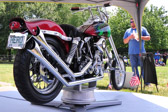 A cluster of dog tags are attached to the front of the hog. Each man is represented by one of those dog tags.<br />And inscription of the seat reads ‘Bring ‘em home or send us back.’ This motorcycle has never been ridden. It can’t until all 37 men come home.
