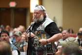 Rolling Thunder Board of Directors member Tom McAtee speaks about a “in honor of” patch he wears.