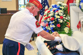 Commandant George Souder places a golden eagle, globe and anchor on Alfred.