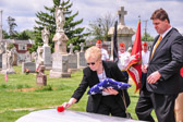 Dorothy places a single red rose of Sarge's casket
