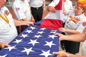 Adjutant PDC Leanna L. Dietrich, Marine Corps League of Pennsylvania, Inc helps in the thirteen folds of our national ensign.