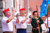Buglers Dan Fitzgerald, Lloyd Spangler playing while Revolutionary War reenactor looks on.