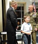 Mark Noah speaks with SgtMaj LeHew while Mark's son Phineas is enjoying himself after ceremonies.
