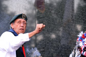 A member of the Black Creek Gourd Society of the Navajo Nation doing a prayer and honoring ceremony. The society has returned to the Wall each Memorial for 4 years to conduct a “Honoring Dance”.