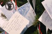 The card reads: Happy Holidays to all my brothers & sisters. May you rest in peace and know that you are not forgotten. With love from 'Doc' & Marian Spresser, Rolling Thunder® National 484-432-7234