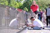 Jim Lee expert stoneworker of Colorado-based Engrave Write along with JC Cummings, AIA, the architect of record for the Vietnam Veterans Memorial go over placement of the names to be added to the wall.