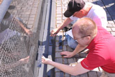 JC and Jim very carefully match the lettering thickness to the area where the name will be added.