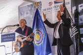 Jan Scruggs introduces Jimmy Buffett and asks all to stand and sing “God Bless America”